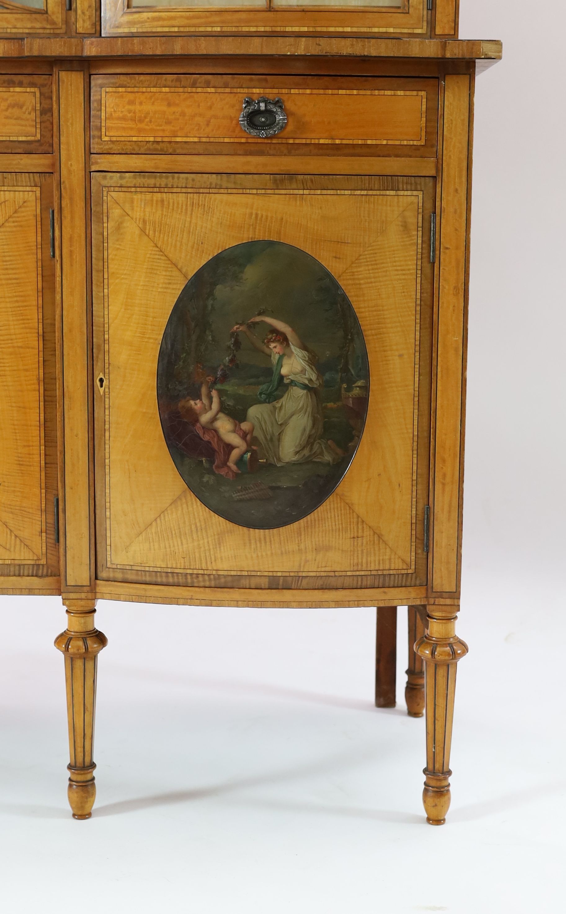 An Edwardian Sheraton revival ebony strung satinwood display cabinet, W.190cm D.47cm H.205cm